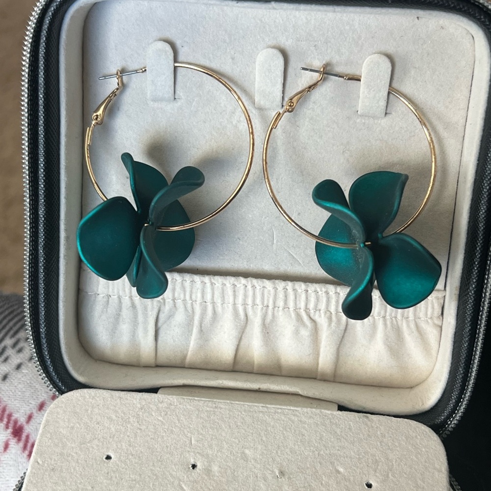Deep teal hoop earrings with flower design